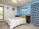 Cozy bedroom with bright blue accent wall and patterned bedding at 112 Cameron Ct, Cary, NC 27511