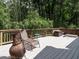 Relax on the deck with wooded views, complete with lounge chair and decorative accents at 112 Cameron Ct, Cary, NC 27511