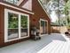 Cozy outdoor space with access to a deck, grill, and well-lit windows at 112 Cameron Ct, Cary, NC 27511