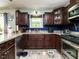 Kitchen featuring wooden cabinets, stainless steel appliances, and granite countertops at 112 Cameron Ct, Cary, NC 27511
