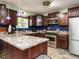Kitchen featuring wooden cabinets, stainless steel appliances, and granite countertops at 112 Cameron Ct, Cary, NC 27511