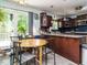 Eat-in kitchen featuring wood table and chairs with wooden cabinets and granite countertops at 112 Cameron Ct, Cary, NC 27511