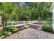 Secluded backyard featuring a patio, a built-in fire pit, and a lovely garden area with lush greenery at 11710 Mezzanine Dr # 101, Raleigh, NC 27614