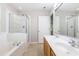 Primary bathroom featuring a dual sink vanity, garden tub, and separate shower at 11710 Mezzanine Dr # 101, Raleigh, NC 27614