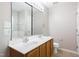 Bathroom featuring double sinks, a large mirror, and a separate toilet area at 11710 Mezzanine Dr # 101, Raleigh, NC 27614