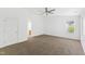 Large bedroom with a window, door and neutral carpet at 11710 Mezzanine Dr # 101, Raleigh, NC 27614