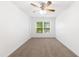 Inviting bedroom with neutral carpet, ceiling fan and a large window overlooking the back yard at 11710 Mezzanine Dr # 101, Raleigh, NC 27614