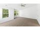 This bedroom includes neutral carpet, multiple windows and a ceiling fan at 11710 Mezzanine Dr # 101, Raleigh, NC 27614