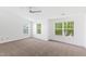 Spacious, neutral bedroom has carpet, a ceiling fan and several windows at 11710 Mezzanine Dr # 101, Raleigh, NC 27614