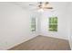 This bright bedroom offers neutral carpet, a ceiling fan and two windows for natural light at 11710 Mezzanine Dr # 101, Raleigh, NC 27614