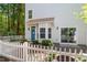 Charming home featuring a blue front door, bay window, and white picket fence at 11710 Mezzanine Dr # 101, Raleigh, NC 27614
