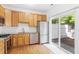 Bright kitchen features stainless steel appliances, granite countertops, wood cabinets and sliding doors at 11710 Mezzanine Dr # 101, Raleigh, NC 27614