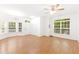 Large living room featuring hardwood floors, generous natural light, and a view into the dining and kitchen areas at 11710 Mezzanine Dr # 101, Raleigh, NC 27614