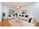 Bright and airy living room featuring neutral decor, plush seating, and large windows for natural light at 11710 Mezzanine Dr # 101, Raleigh, NC 27614