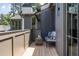 This balcony features a cushioned chair, an end table, and wood-paneled floors at 1222 Duplin Rd, Raleigh, NC 27607