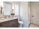 This bathroom features a white quartz countertop, a wooden vanity, and a glass shower enclosure at 1222 Duplin Rd, Raleigh, NC 27607