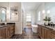 This bathroom features dual vanities with black marble countertops, a standalone tub, and a shower in the background at 1222 Duplin Rd, Raleigh, NC 27607