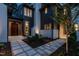 Home entryway featuring stone walkway, wood door, painted brick details and manicured landscaping at 1222 Duplin Rd, Raleigh, NC 27607