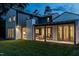This home features an outdoor patio, a large yard, white brick, and dark siding at 1222 Duplin Rd, Raleigh, NC 27607