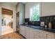 Bright kitchen with custom cabinets, marble countertops, stainless steel appliances and a window at 1222 Duplin Rd, Raleigh, NC 27607