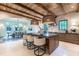 Spacious kitchen featuring a large center island, wooden cabinets, stone accents and modern lighting at 1222 Duplin Rd, Raleigh, NC 27607