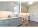 This laundry room features light gray cabinets, a white countertop, and decorative terra-cotta tile flooring at 1222 Duplin Rd, Raleigh, NC 27607