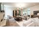 Bright, open living room featuring a fireplace, French doors, stone accents and modern furnishings at 1222 Duplin Rd, Raleigh, NC 27607