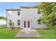 Exterior view of the home's backyard featuring a lush lawn and concrete patio at 124 Owensboro Ct, Raleigh, NC 27603