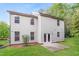Exterior view of the home's backyard featuring a lush lawn and concrete patio at 124 Owensboro Ct, Raleigh, NC 27603