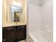 Bathroom featuring vanity with dark cabinets, and a tub/shower combo with white tile at 124 Owensboro Ct, Raleigh, NC 27603