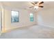 Spacious bedroom featuring neutral walls, carpeted floors, ceiling fan and natural light from the two windows at 124 Owensboro Ct, Raleigh, NC 27603