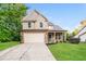 Charming two-story home features a two-car garage and manicured front lawn at 124 Owensboro Ct, Raleigh, NC 27603