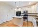 Kitchen boasts granite countertops, stainless steel appliances, and center island at 124 Owensboro Ct, Raleigh, NC 27603