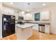 Kitchen boasts granite countertops, stainless steel appliances, and center island at 124 Owensboro Ct, Raleigh, NC 27603
