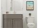 Bathroom featuring a grey vanity, white countertop, decorative plant, and modern fixtures at 1244 Hazelnut Ridge Ln, Knightdale, NC 27545