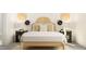 Bedroom featuring natural textures, decorative wall hangings, and bedside table decor at 1244 Hazelnut Ridge Ln, Knightdale, NC 27545