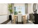 Elegant dining room with a chandelier, modern table, and stylish black sideboard at 1244 Hazelnut Ridge Ln, Knightdale, NC 27545