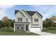 Charming two-story home with stone accents, gray siding, and a covered front porch at 1244 Hazelnut Ridge Ln, Knightdale, NC 27545