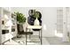 Home office with stylish black desk chair, decorative plant, and modern art for a creative space at 1244 Hazelnut Ridge Ln, Knightdale, NC 27545