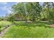 Lush, green backyard with mature trees, showcasing the home's exterior and serene setting at 129 Trellingwood Dr, Morrisville, NC 27560