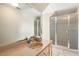 Bathroom featuring a double glass shower, a large mirror, and neutral tiling, promoting a bright, refreshing space at 129 Trellingwood Dr, Morrisville, NC 27560