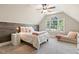 A cozy bedroom features a decorative wood accent wall, a window view, and soft textures for a serene retreat at 129 Trellingwood Dr, Morrisville, NC 27560