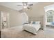 Bright bedroom featuring a ceiling fan, window seat, and attached bath providing comfort and convenience at 129 Trellingwood Dr, Morrisville, NC 27560