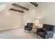 Large bonus room with custom ceiling beams, recessed lighting, and two sitting chairs at 129 Trellingwood Dr, Morrisville, NC 27560