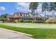 Elegant clubhouse with brick exterior and manicured green lawn, offering a luxurious and inviting community gathering space at 129 Trellingwood Dr, Morrisville, NC 27560