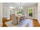 Elegant dining room showcases natural light, classic columns, and a rustic dining table for gatherings at 129 Trellingwood Dr, Morrisville, NC 27560
