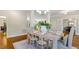 The dining room features classic columns, a decorative chandelier, and a beautifully set table for memorable gatherings at 129 Trellingwood Dr, Morrisville, NC 27560