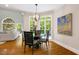 Cozy dining area with hardwood floors, natural light, and seating for four, adjacent to the living room at 129 Trellingwood Dr, Morrisville, NC 27560