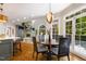 Cozy dining area with hardwood floors, natural light, and seating for four, open to the kitchen and living room at 129 Trellingwood Dr, Morrisville, NC 27560