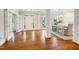 Grand foyer boasts gleaming hardwood floors, elegant columns, and abundant natural light streaming through the French doors at 129 Trellingwood Dr, Morrisville, NC 27560